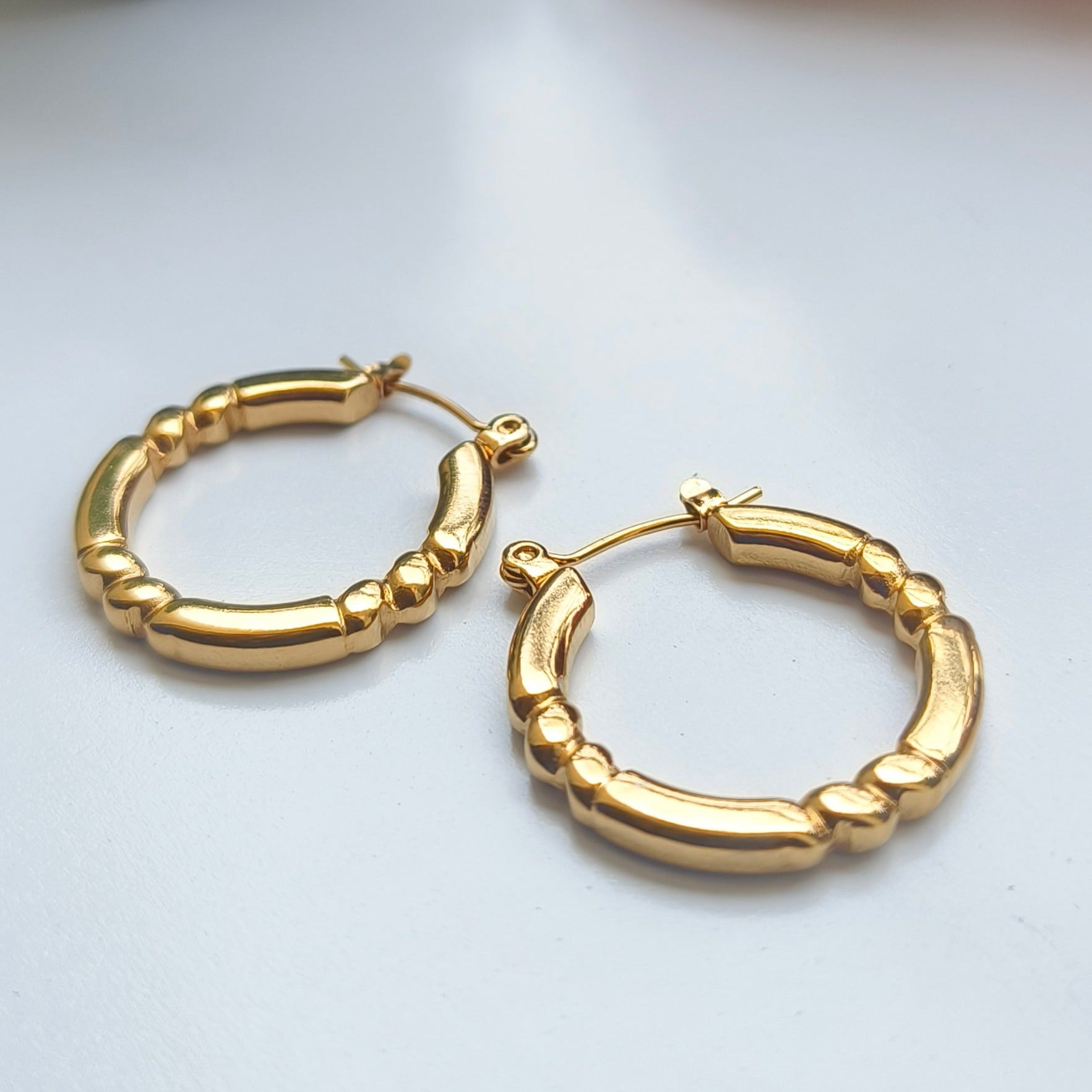 Discover timeless elegance with Melody Golden SS#22 Hoops Earrings. Crafted in 18K gold-plated stainless steel with cubic zirconia stones, these lightweight and versatile hoops add a touch of luxury to any outfit. Elevate your style today!