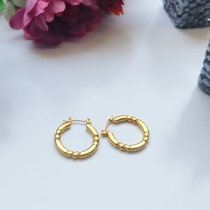 Discover timeless elegance with Melody Golden SS#22 Hoops Earrings. Crafted in 18K gold-plated stainless steel with cubic zirconia stones, these lightweight and versatile hoops add a touch of luxury to any outfit. Elevate your style today!