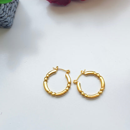 Discover timeless elegance with Melody Golden SS#22 Hoops Earrings. Crafted in 18K gold-plated stainless steel with cubic zirconia stones, these lightweight and versatile hoops add a touch of luxury to any outfit. Elevate your style today!