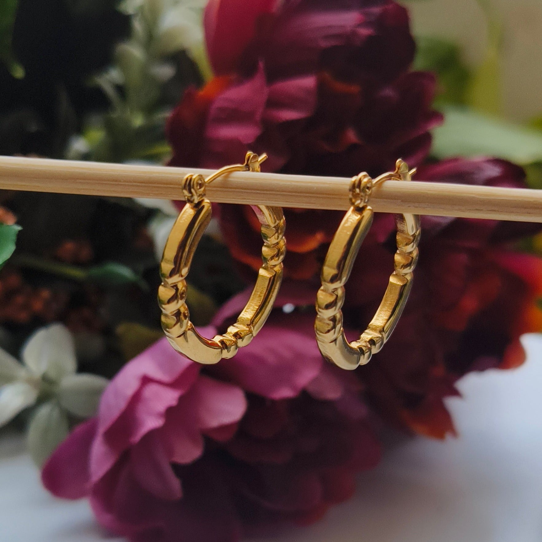 Discover timeless elegance with Melody Golden SS#22 Hoops Earrings. Crafted in 18K gold-plated stainless steel with cubic zirconia stones, these lightweight and versatile hoops add a touch of luxury to any outfit. Elevate your style today!